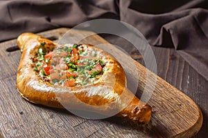 Ajarian traditional flatbread - khachapuri or hachapuri with meat and vegetables and cheese. Copy text area for menu design or