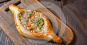 Ajarian traditional flatbread - khachapuri or hachapuri with meat and vegetables and cheese. Copy text area for menu design or