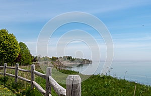 Ajax, Ontario lakefront park, wooden fence, trees, blue sky, Lake Ontario