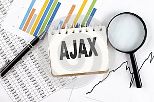 AJAX text on notebook on the graph background with pen and magnifier