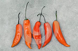 Aji amarillo hot chili peppers on stone background