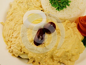 Aji de gallina, typical dish from Peruvlan food with con eggs rice plate