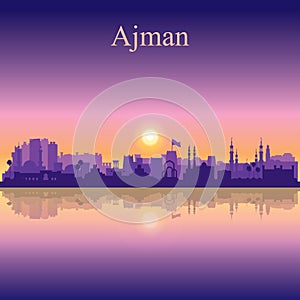 Ajman silhouette on sunset background photo