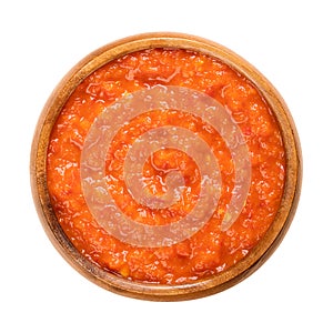 Ajvar, relish made of roasted sweet bell peppers, in a wooden bowl