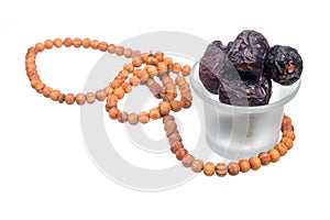 Ajwa  Dates and  rosary on  white background. Ajwa dates is favoured by Prophet Muhammad SAW