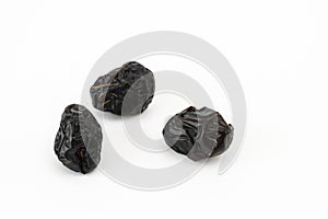 Ajwa dates on a white background