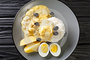 AjÃ­ de gallina is a classic Peruvian dish made with ajÃ­ peppers, chicken, and a cream sauce with rice in the plate. Horizontal