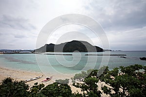 Aka bridge and zamami island under cloudy sky photo