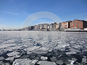 Aker Brygge in Oslo and ice floes in the Oslofjord, Norway photo