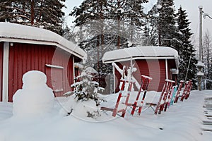 Akeslompolo typical sledges in front of red cabins