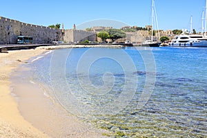 Akti sachtouri sand beach in old town Rhodes with city walls in Rhodes