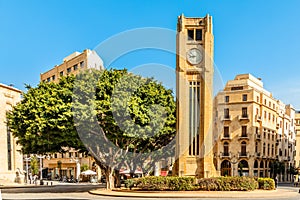 Al-Abed Nejmeh Square clock tower with tree and buildings around, Beirut, Lebanon