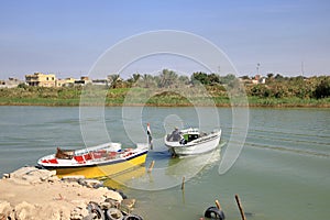 Al-Qurna, Basra, Iraq - November 11 2024: people enjoy a boat trip at the Euphrates and Tigris confluence, Shatt al-Arab photo