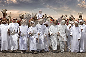 Men with their camels in a desert