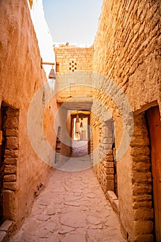 Al Ula old town street between mud bricked walls , Saudi Arabia