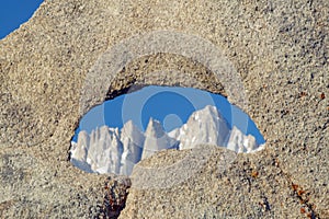 The Alabama Hills hole in rock framing Mount Whitney and the snowy Sierra Mountains at sunrise near Lone Pine, CA photo