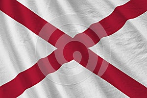 Alabama US state flag with big folds waving close up under the studio light indoors. The official symbols and colors in