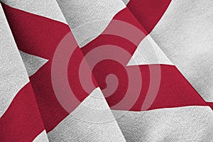 Alabama US state flag with big folds waving close up under the studio light indoors. The official symbols and colors in