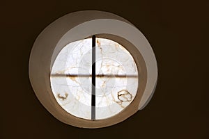 Alabaster round window with cross difussed light