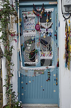 Alacati has a wonderful village gate, decorated with scarves, lace, classic blue painted door