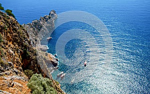 Alanya castle top view on the mountain with coast ferry boat on blue sea and harbor background - Beautiful cleopatra beach Alanya