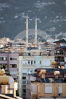 The Alanya cityscape with minarets of mosque and residential houses in center of city. Antalya Province, Turkey