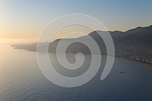 Alanya, Turkey - August, 8, 2019: View to the Alanya Deniz Feneri Alanya lighthouse from the beach.  People relax on the Mediter