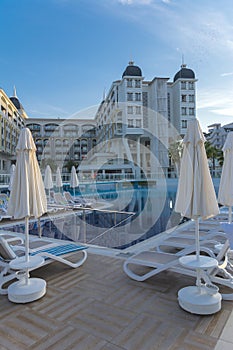 Alanya, Turkey - October 05, 2018. Beautiful pool in Kirman Sidera Luxury hotel with clear blue water on background of sea, blue