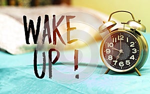 Alarm 7 o` Clock above alarm showing 7 o` Clock above bed with wake up ! concept bed