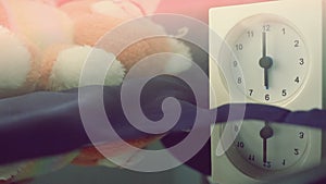 Alarm clock 6 o` clock in the morning on the bed at home. Morning time background concept.