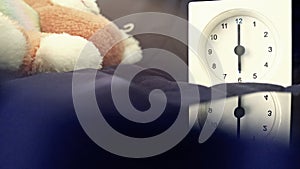 Alarm clock 6 o` clock in the morning on the bed at home. Morning time background concept.