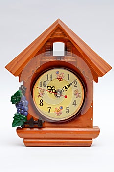 Alarm clock as a small house on a white background