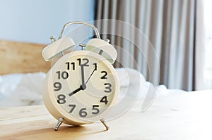 Alarm clock in bedroom with lighting morning