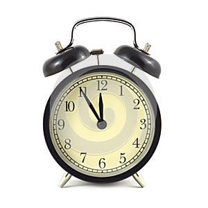 Alarm clock in black case and beige clockface isolated close up photo