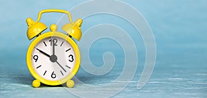 Alarm clock on blue background, save or manage time concept photo