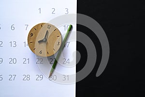 Alarm clock and calendar on the black background, planning for business meeting or travel planning concept