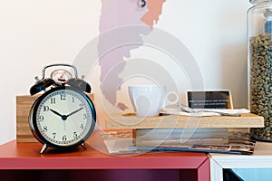 Alarm clock with coffee beans in glass bowl and coffee cup