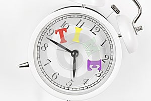 Alarm clock with coloful letters word time on white