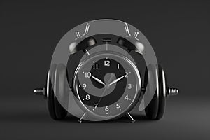 Alarm clock with dumbbells on dark background. Working out concept, fitness, sport activity, healthy lifestyle theme, consistency