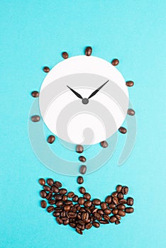 Alarm clock flower made from coffee beans, wake up in the morning, having a deadline, time for a break, minimalistic concept, blue