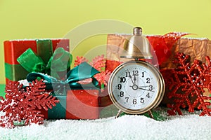 Alarm clock with gifts on color background. Christmas countdown