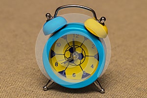 Alarm clock isolated on intage linen background