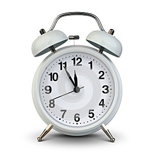 Alarm clock isolated on white, clipping path. Five minutes to twelve