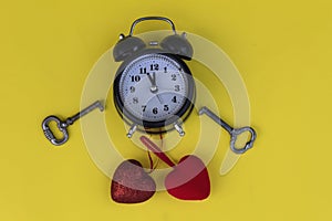 Alarm clock, keys and red hearts.