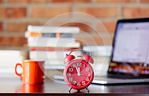 Alarm clock with laptop computer and books