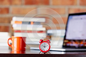 Alarm clock with laptop computer and books