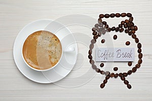 Alarm clock made of beans and card with phrase Coffee Break near hot drink on white wooden table, flat lay