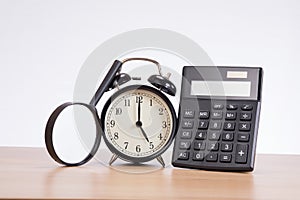 Alarm clock between magnifier and calculator