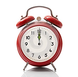 Alarm clock at midnight hour on white background