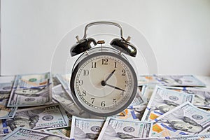 Alarm clock on money banknotes Dollars,concept of business planning and finance. Usurer, credit concept. Time for quick money.